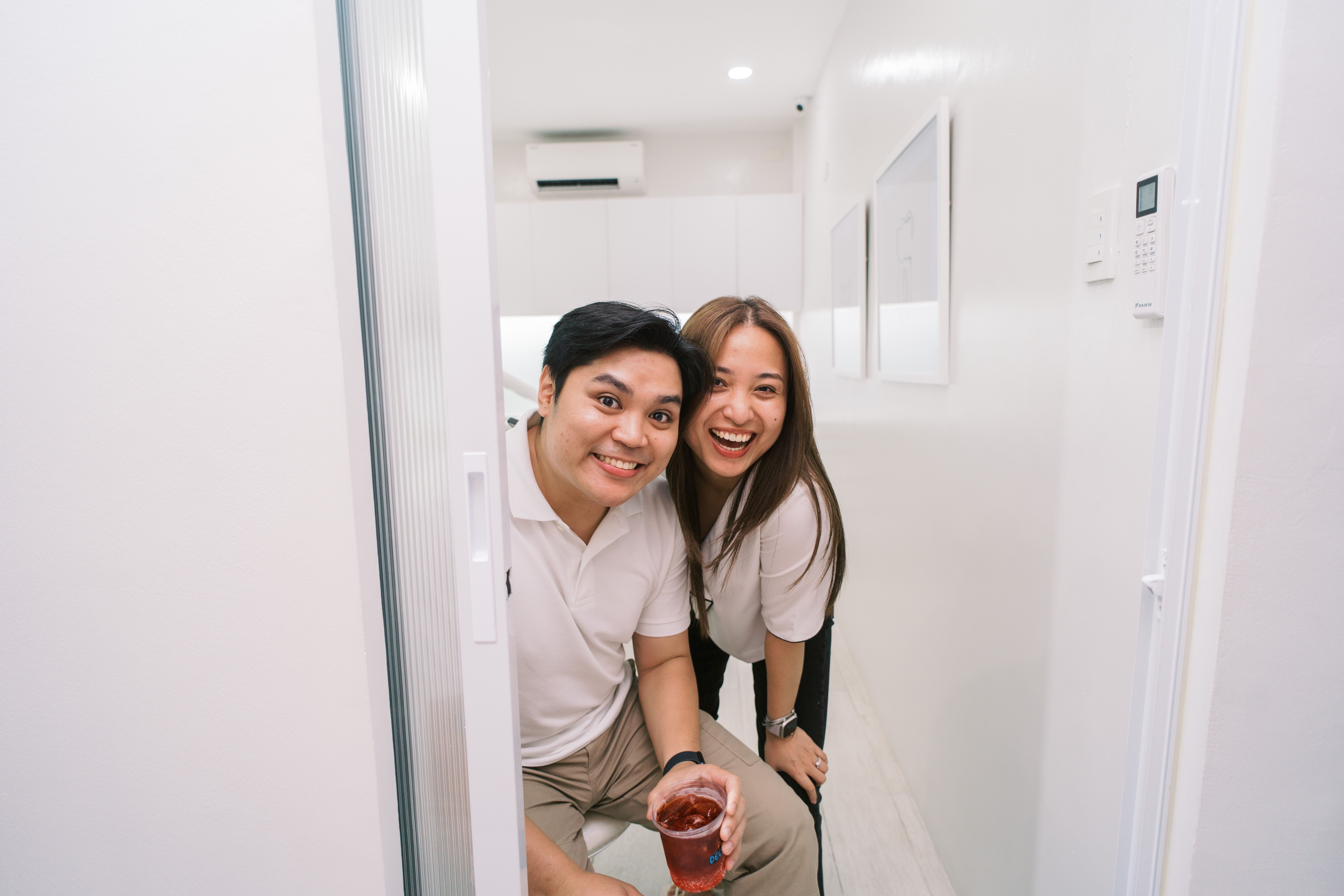 Two guests smiling inside Cura Dental
